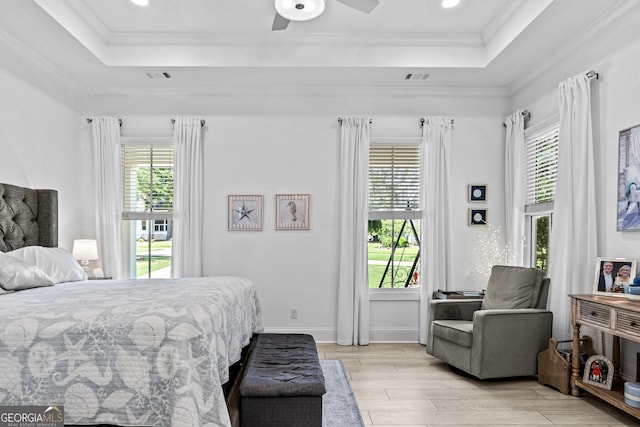 bedroom with crown molding, ceiling fan, and a tray ceiling