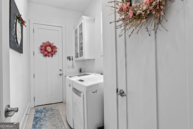 laundry room with cabinets and washing machine and clothes dryer