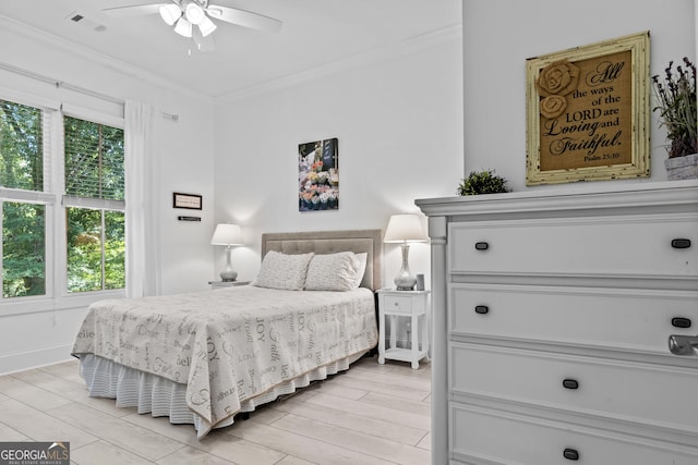 bedroom with ornamental molding, ceiling fan, and light hardwood / wood-style flooring