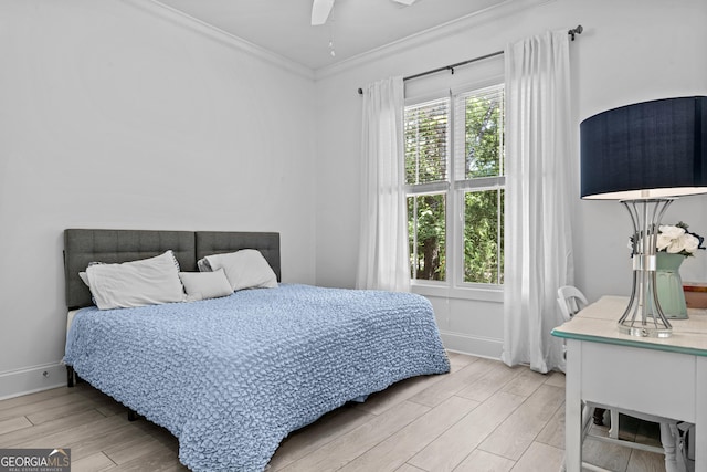 bedroom with ornamental molding, ceiling fan, and light wood-type flooring