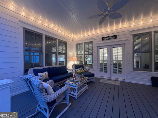 wooden terrace with french doors, ceiling fan, and an outdoor living space