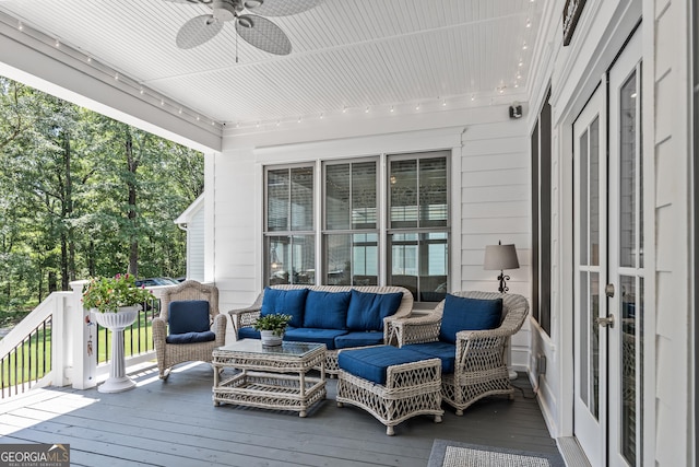 wooden terrace with an outdoor hangout area and ceiling fan