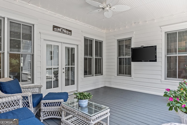 wooden deck with an outdoor hangout area, ceiling fan, and french doors