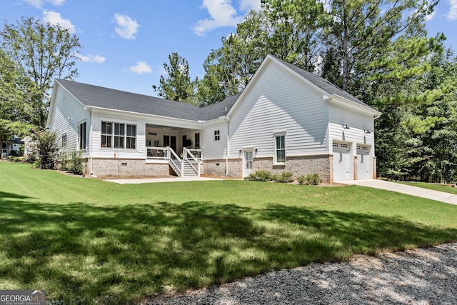 back of property with a garage, a lawn, and a porch