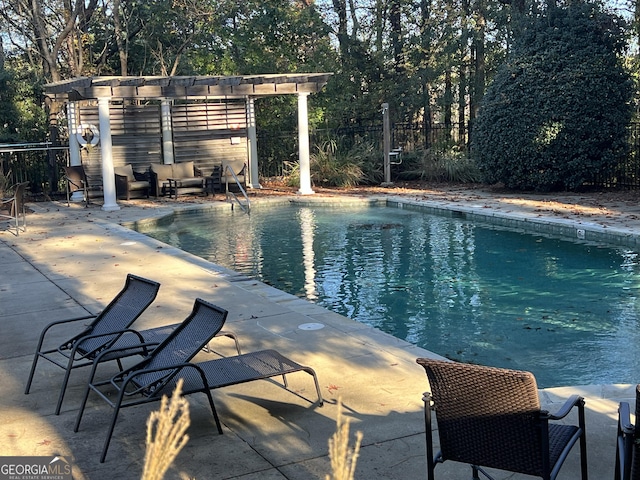 view of pool with an outdoor hangout area, a pergola, and a patio area