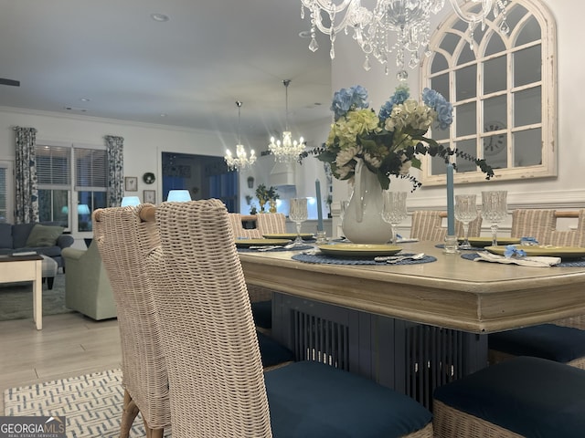 dining space with crown molding and a notable chandelier