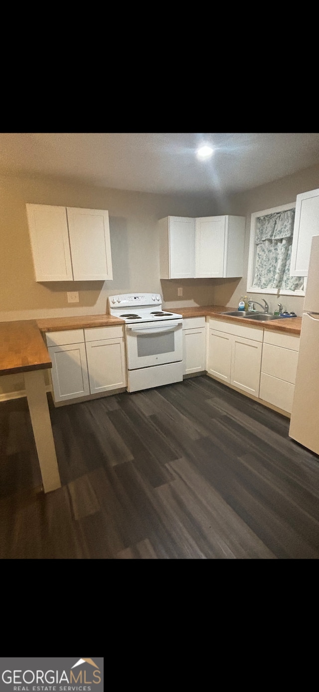 kitchen with white cabinetry, sink, dark wood-type flooring, and white appliances