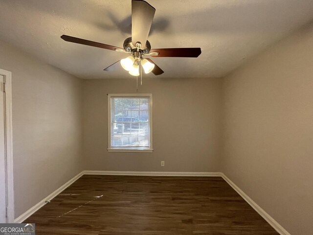 unfurnished bedroom with ceiling fan and dark hardwood / wood-style floors