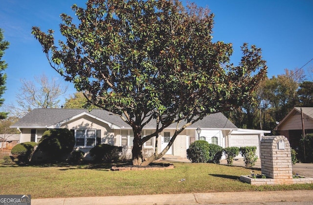 view of front of property with a garage and a front yard