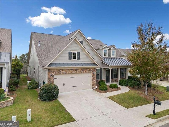 view of front of home with a garage and a front lawn