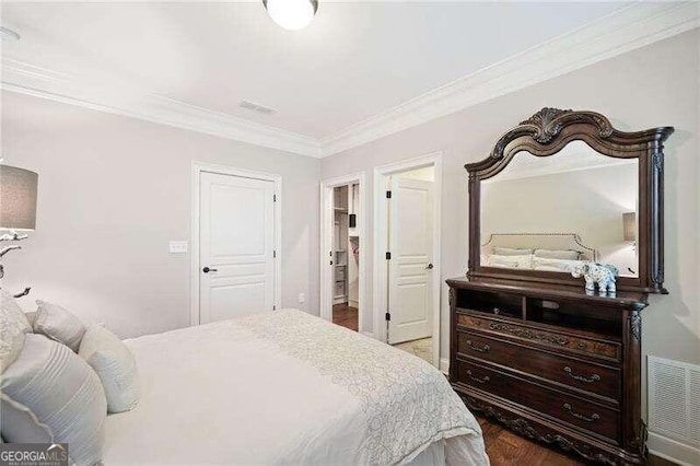 bedroom with dark hardwood / wood-style floors, a closet, and ornamental molding