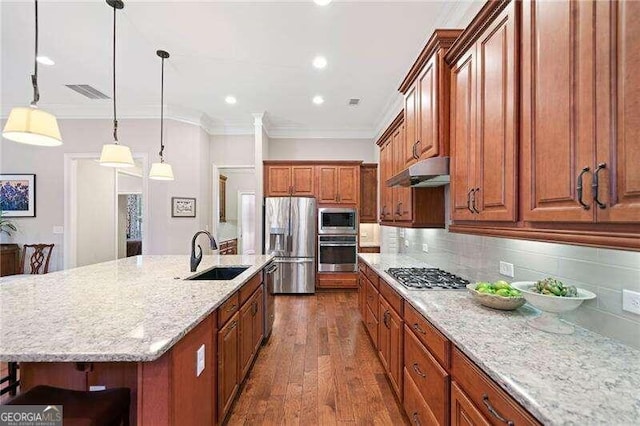 kitchen with stainless steel appliances, a spacious island, sink, decorative light fixtures, and dark hardwood / wood-style floors