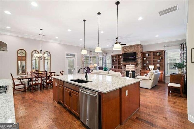 kitchen featuring stainless steel appliances, light stone counters, a kitchen island with sink, and dark hardwood / wood-style floors