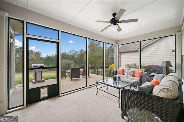 sunroom / solarium with ceiling fan and a healthy amount of sunlight