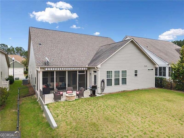 rear view of house with a lawn, a patio area, a sunroom, and outdoor lounge area