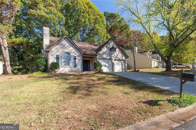 ranch-style house with a garage and a front yard