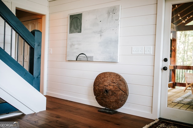 interior details featuring wooden walls and hardwood / wood-style floors