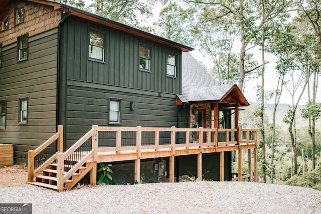 rear view of property featuring a deck