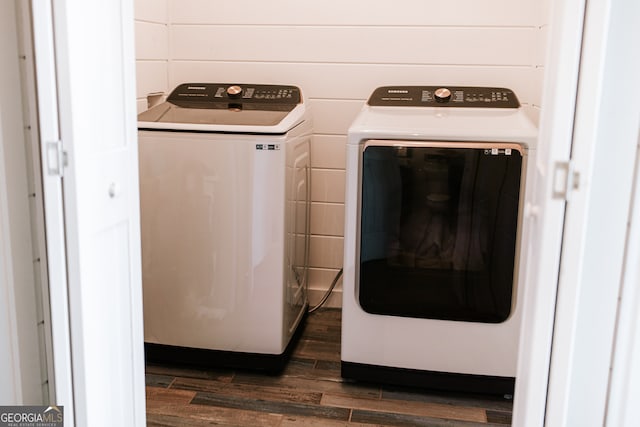 laundry room with dark hardwood / wood-style flooring and separate washer and dryer