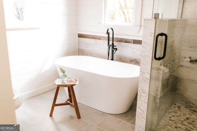 bathroom with tile patterned flooring, toilet, and independent shower and bath