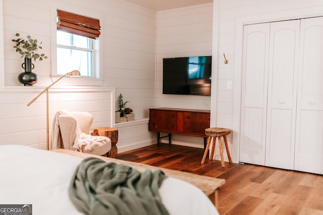 bedroom with hardwood / wood-style floors and a closet