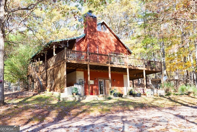 back of house with a wooden deck