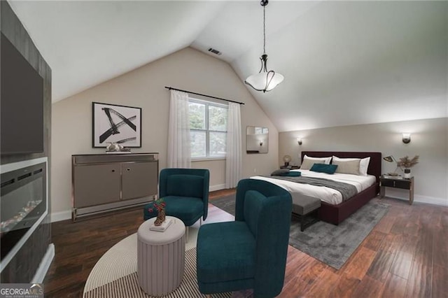 bedroom featuring dark hardwood / wood-style floors and vaulted ceiling