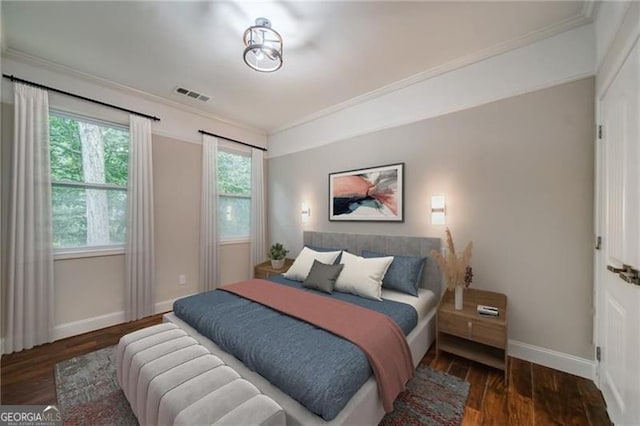 bedroom featuring crown molding and dark hardwood / wood-style flooring