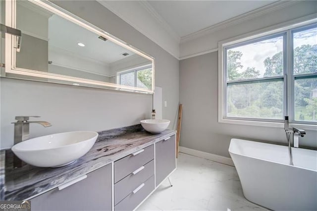 bathroom featuring a tub, a wealth of natural light, vanity, and ornamental molding