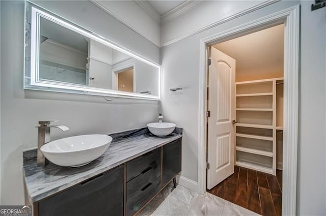 bathroom featuring crown molding, vanity, and hardwood / wood-style flooring