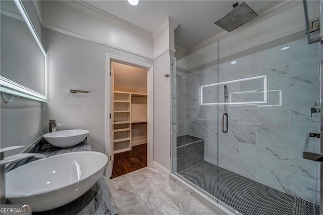 bathroom with walk in shower, sink, and ornamental molding