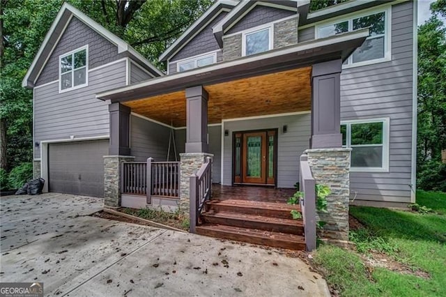 view of front of house with covered porch and a garage