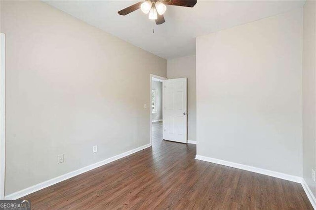 spare room featuring ceiling fan and dark hardwood / wood-style flooring