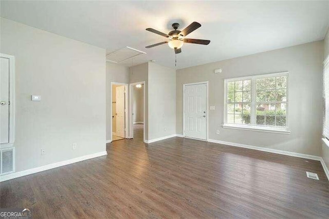 unfurnished living room with ceiling fan and dark hardwood / wood-style flooring