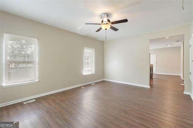 unfurnished room featuring ceiling fan and dark hardwood / wood-style flooring