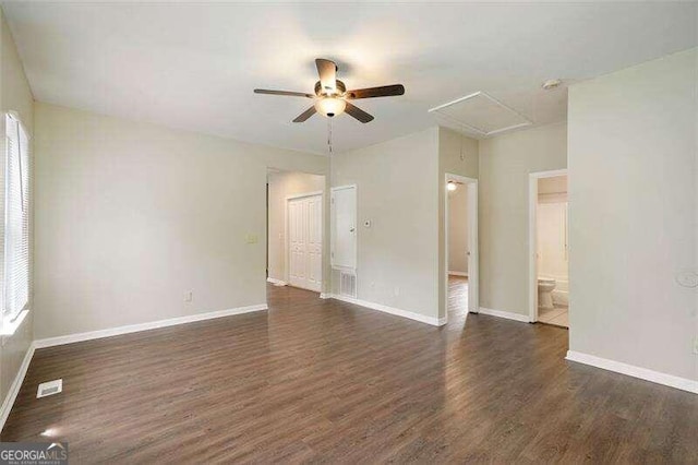 empty room featuring ceiling fan and dark hardwood / wood-style flooring