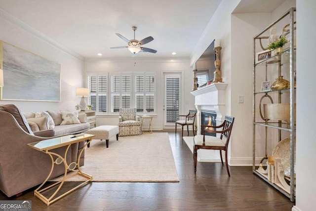 living room with plenty of natural light, dark wood-type flooring, and ornamental molding