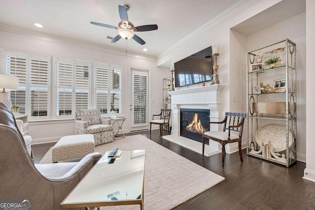 living room with dark hardwood / wood-style floors, ceiling fan, and crown molding