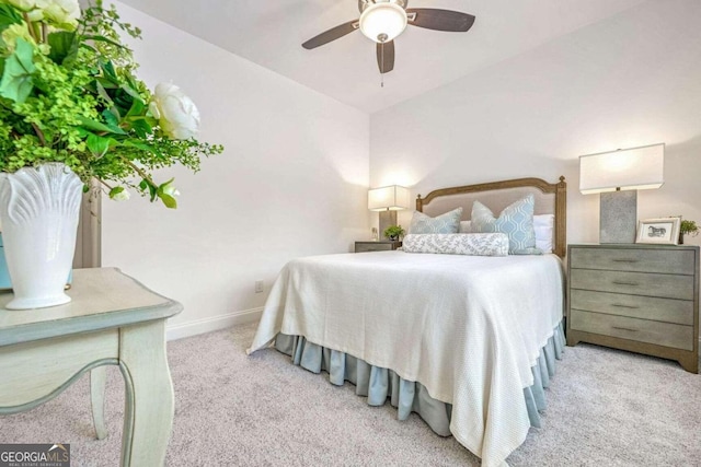 bedroom featuring ceiling fan, light carpet, and lofted ceiling