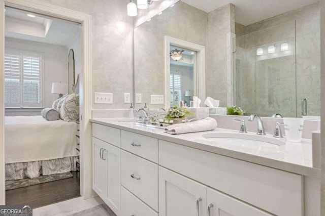 bathroom with vanity, a shower with door, a wealth of natural light, and ceiling fan