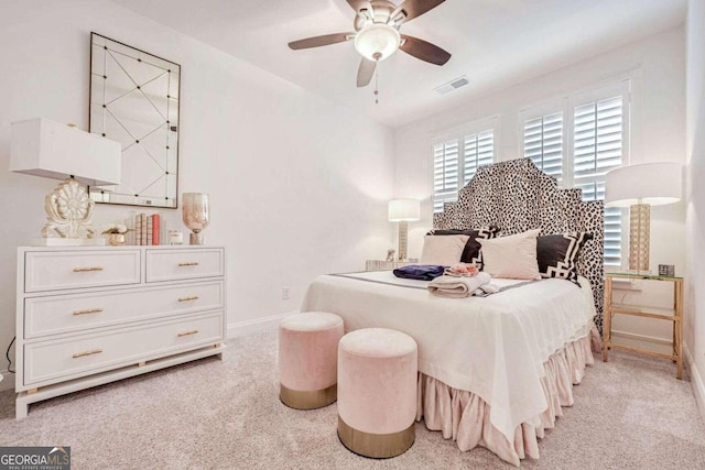 bedroom featuring light colored carpet and ceiling fan