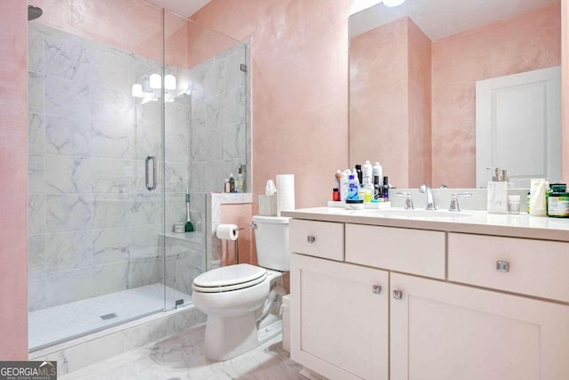 bathroom featuring vanity, toilet, and an enclosed shower