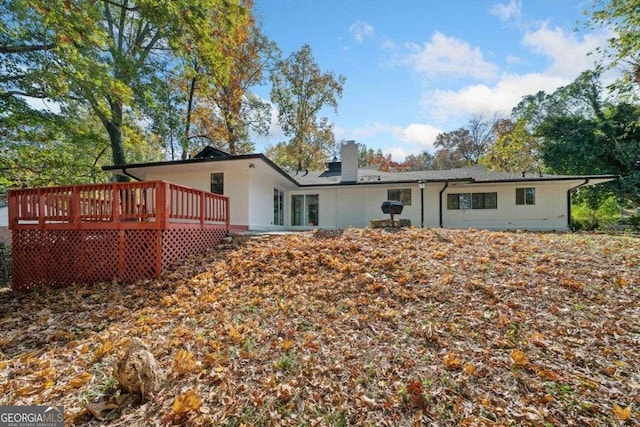 rear view of house featuring a deck