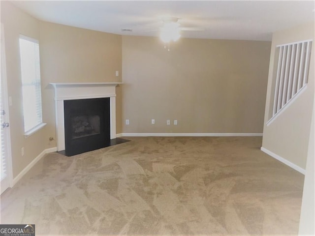 unfurnished living room with ceiling fan and light colored carpet