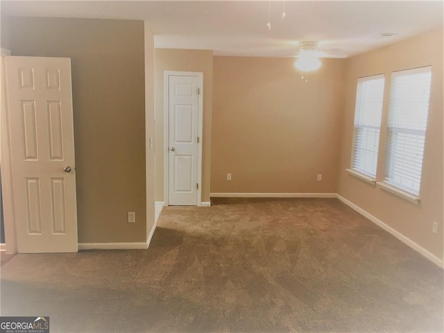 carpeted empty room featuring ceiling fan