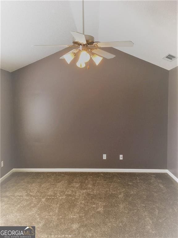 unfurnished room featuring carpet floors, vaulted ceiling, and ceiling fan