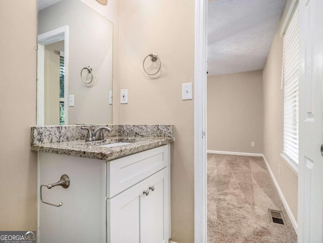 2887 Rockcliff Rd SE, Atlanta, GA 30316 - bathroom featuring vanity, baseboards, and a textured ceiling