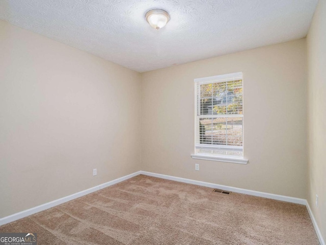 2887 Rockcliff Rd SE, Atlanta, GA 30316 - carpeted spare room with baseboards and a textured ceiling