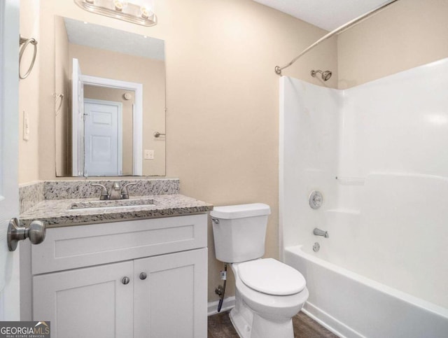 full bathroom with vanity, toilet, and washtub / shower combination