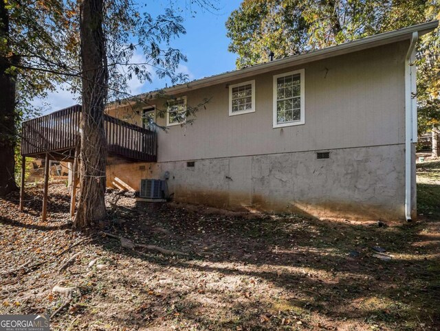 2887 Rockcliff Rd SE, Atlanta, GA 30316 - view of side of home featuring crawl space, central AC unit, and a deck